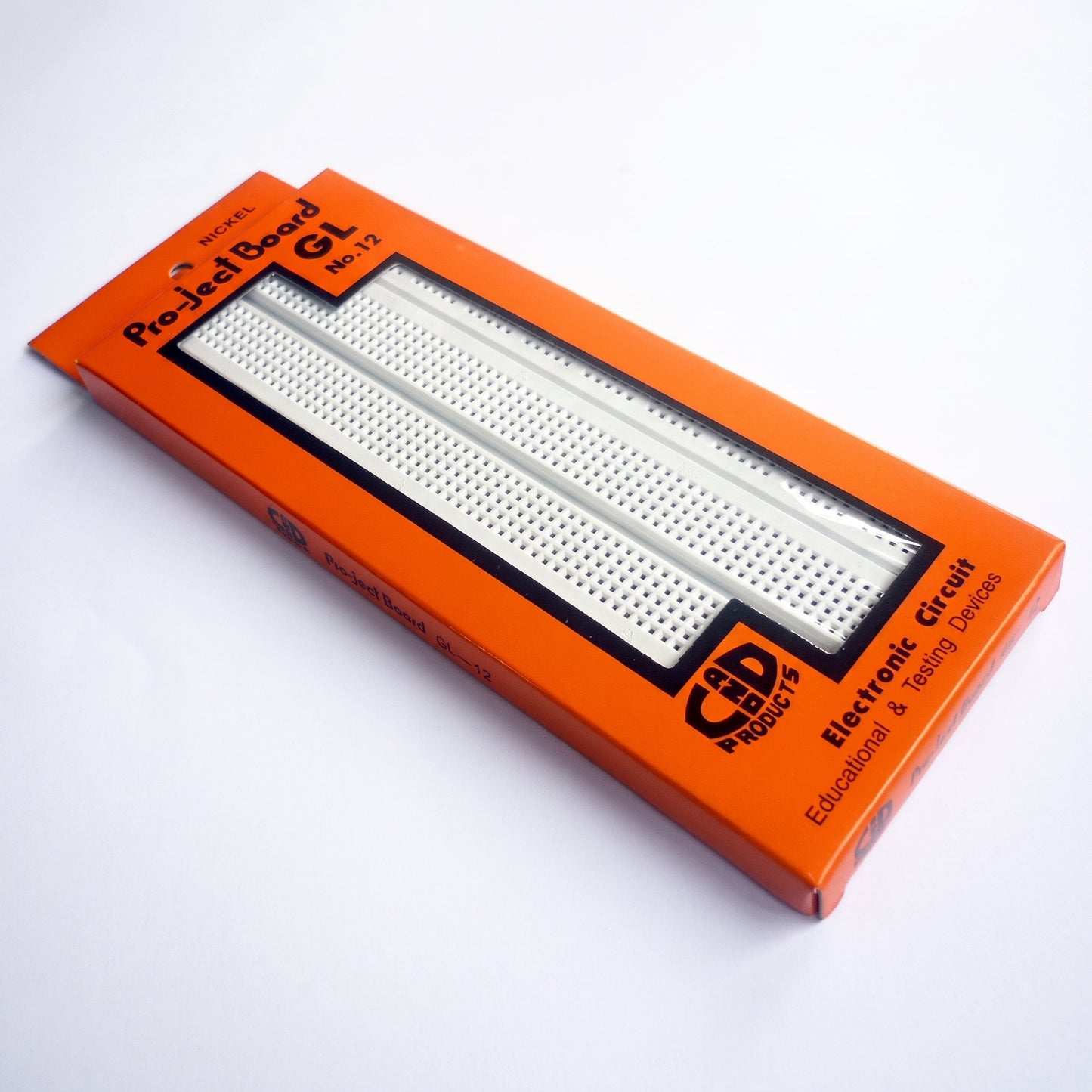 GL-12 breadboard in orange packaging lifestyle view showing white solderless breadboard