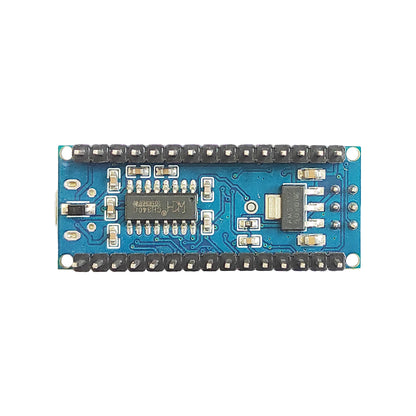 Arduino Nano blue development board lifestyle view on workbench with pin headers visible