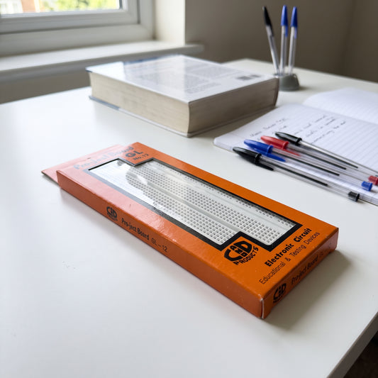 GL-12 breadboard product view in orange packaging showing white solderless breadboard